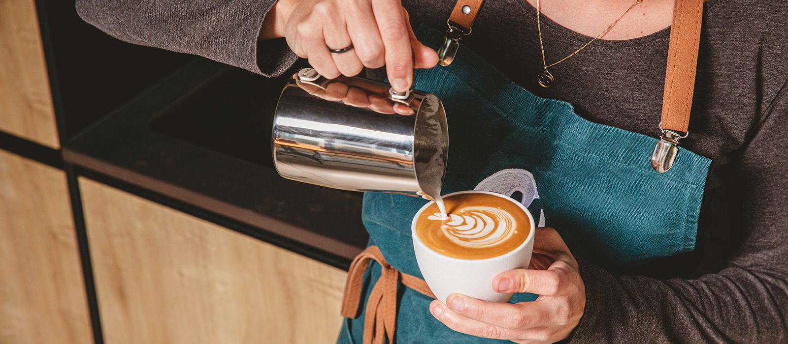 Professional barista preparing coffee at Andless Café